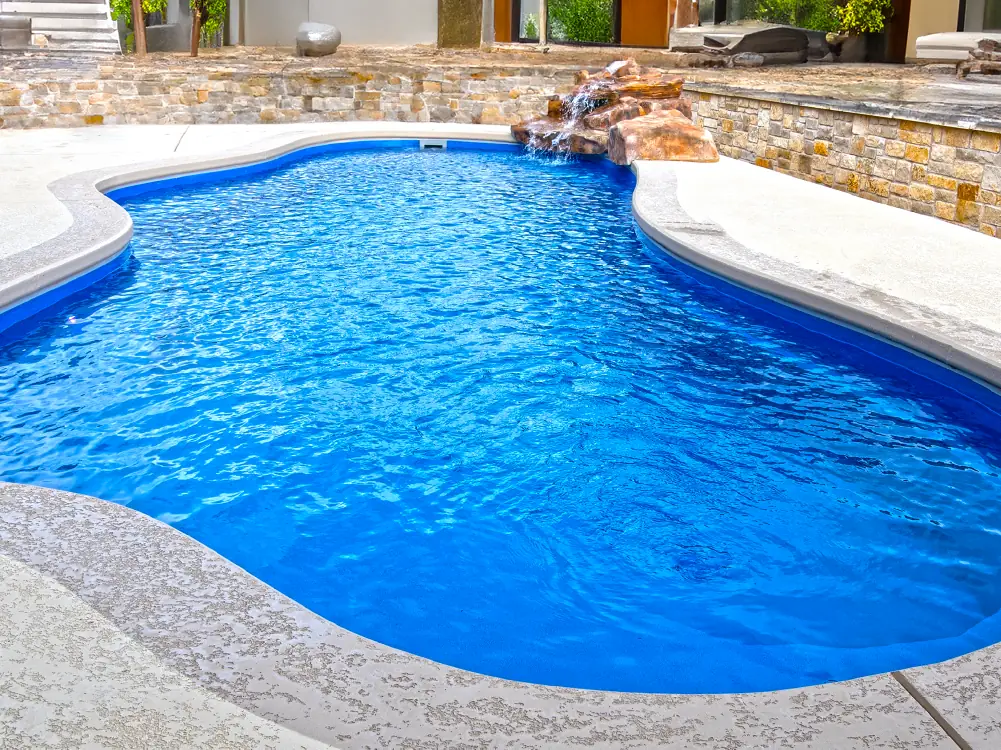 The Eden fiberglass pool boasts an elegant splah pad and welcoming swim area